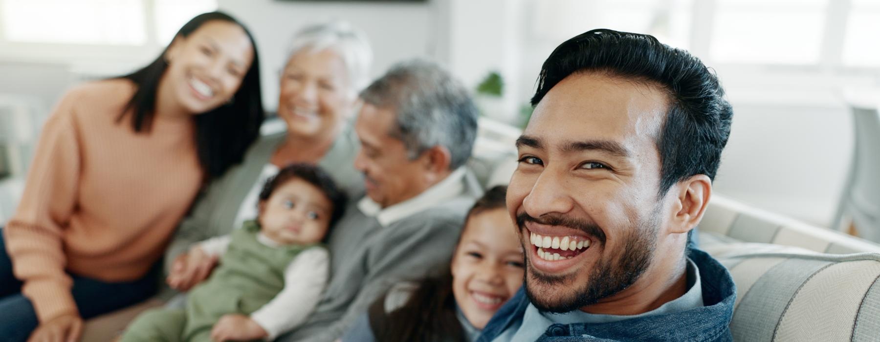 a large family sitting together and smiling