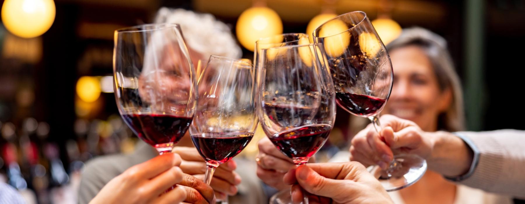 a group of people holding wine glasses